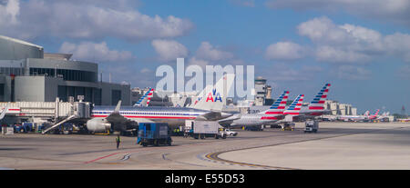 Commercial passenger planes lined up at gates at airport Stock Photo