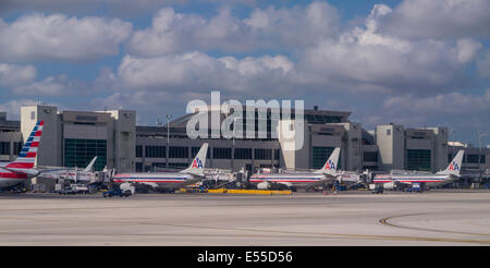 Commercial passenger planes lined up at gates at airport Stock Photo