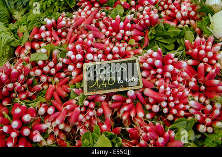 Bunches of radishes for sale on a market stall in Chamonix, Haute-Savoie, France. Stock Photo