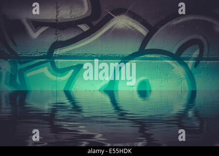 Graffiti reflection in the water, artistic chrome letters Stock Photo