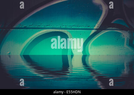 Graffiti reflection in the water, artistic chrome letters Stock Photo