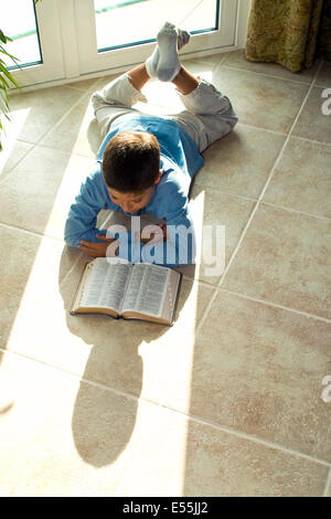 boy reading Bible multicultural multi-cultural Young Japanese/Caucasian 10-11 year years old children sunlight  MR © Myrleen Pearson Stock Photo
