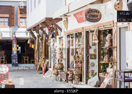 Shops in Kusadasi, Turkey, selling souvenirs displaying local pottery, ceramics, rugs, carpets and statues Stock Photo