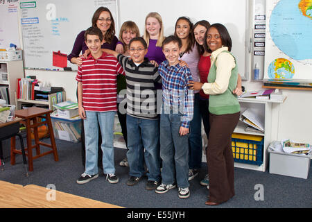 Boys girls school class Interracial Multi ethnic racial Ethnically diverse hanging out 11-13 year years old  teacher & teacher's aide smiling camera. MR Stock Photo