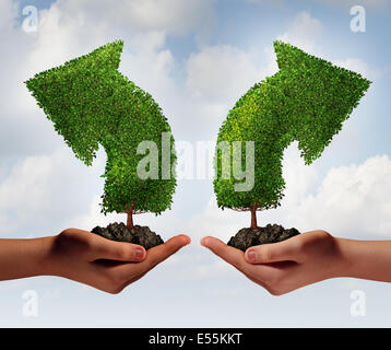 Growth choice and business guidance concept as two human hands holding up trees shaped as an arrow growing in opposite directions as a crossroad metaphor for choosing the right option for career or financial success. Stock Photo