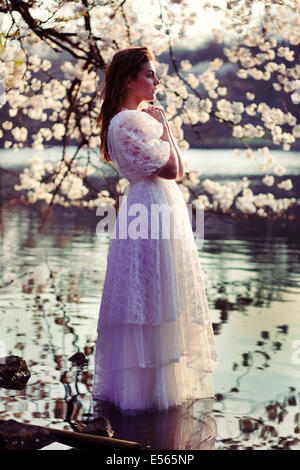 Portrait of a young woman with cherry blossoms Stock Photo