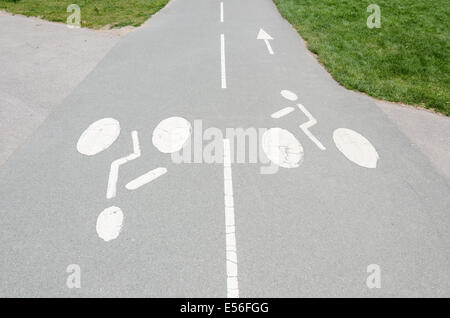 Directional cycling symbols painted on a two-way bike path Stock Photo