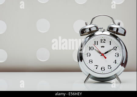 classical alarm clock on vintage background Stock Photo