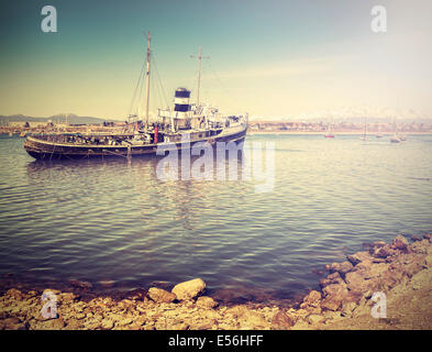 Vintage photo of old ship wreck in harbour. Stock Photo