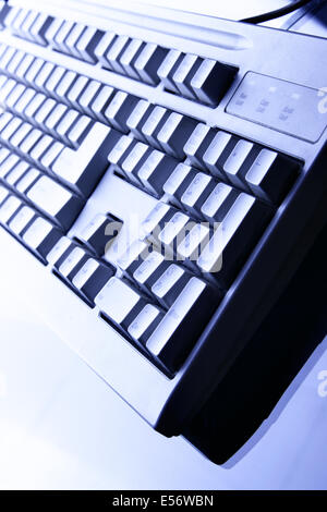 Computer keyboard close up in blue light Stock Photo