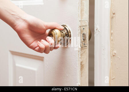 Hand opening door knob Stock Photo