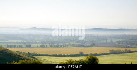 Early morning ground fog lying over fields in the Vale of Pewsey, near Alton Barnes, Wiltshire, England Stock Photo