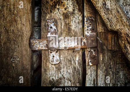 Old latch on the old wooden door. Stock Photo