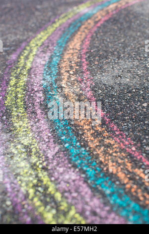 chalk drawing of rainbow and color chalks on asphalt Stock Photo