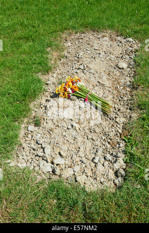 Simple Grave With Flowers At Sun Rising Natural Burial Ground and Nature Reserve in Tysoe Warwickshire UK Stock Photo