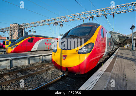 Two Virgin Class 390 Pendolino trains in the platforms of Manchester Piccadilly Rail Station. Stock Photo