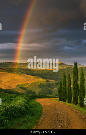 Rainbow with famous Cypress trees in the heart of the Tuscany, near Pienza, Italy Stock Photo