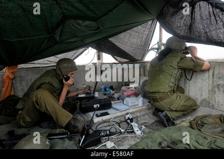 Israeli soldiers from the Field Intelligence Corps scan Beersheba skyline with binoculars to identify locations that were hit by rockets fired from Gaza strip. The Field Intelligence Corps, is responsible for collecting visual information on the battlefield and rapidly transferring it to other forces. Stock Photo