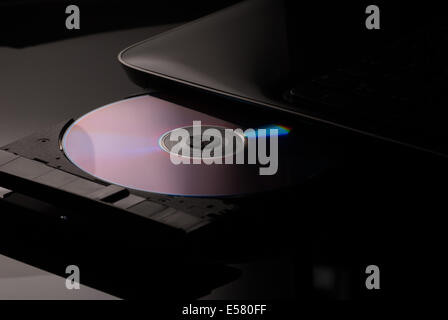 Compact disc drive with on black black background Stock Photo