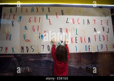 Buenos Aires, Argentina. 22nd July, 2014. A kid plays with a board during the 24th Fair of the Child and Youth Book, in Buenos Aires, capital of Argentina, on July 22, 2014. The fair, with the participation of around 100 exhibitors and over 300,000 visitors, is one of the few fairs in the world dedicated completly to the diffusion of the books among children and youngsters, according to local press. Credit:  Martin Zabala/Xinhua/Alamy Live News Stock Photo