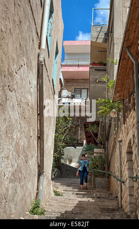 A woman walks down an alleyway in the old city, Nazareth, Israel. Stock Photo