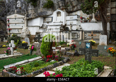 Fresh flowers adorn graves and burial vaults of the village cemetery, Porto Venere, Italy Stock Photo
