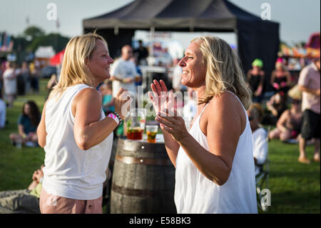 Two women enjoying themselves at the Brentwood Festival in Essex. Stock Photo