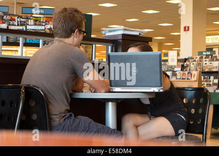 Young man and woman at bookstore. Stock Photo