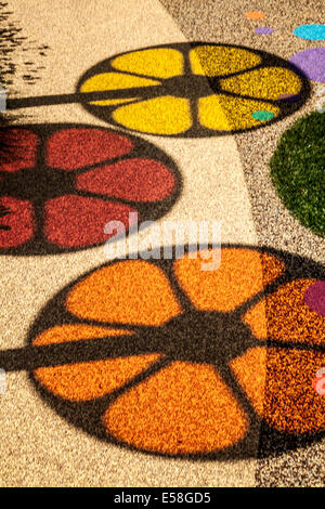 Tatton Park, Manchester, UK. 23rd July, 2014.  Circular Images. and Coloured shadows, coloured circles, spinning wheels, shadows of colour,  red, yellow orange patterns, round, vector, abstract, design, graphic, illustration, light, colours, bright, spectrum, element, art, colorful, icon, colour, color, palette, motion, pattern, blue, creative, fun spectrum on garden pathway at the RHS - Royal Horticultural Society  carnival-themed event at Tatton Park. Stock Photo