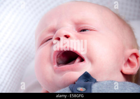 Baby just woken up in his nursery crying out for attention Stock Photo