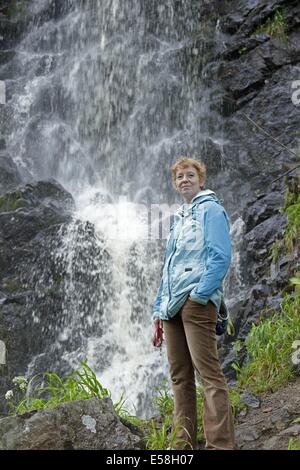 woman standing in front of Radau Waterfall, Bad Harzburg, Lower Saxony, Germany Stock Photo