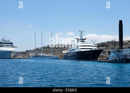 Octopus  Super Yacht moored in Grand Harbour Malta astern of the tug boat St Gabriel & ahead of Le Ponant a 3 mast yacht Stock Photo