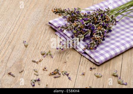 Purple flowers of lavender on a cloth and wood Stock Photo