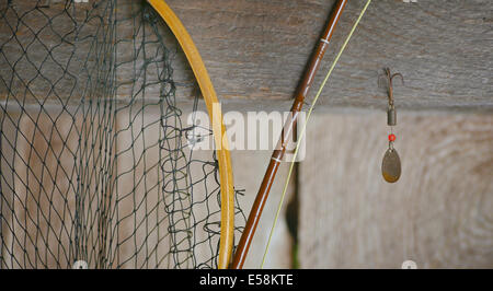 Fishing tackle hung against rough wood background Stock Photo