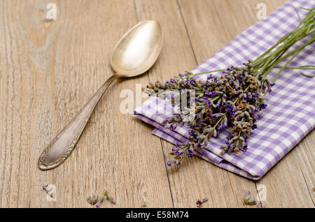 Spoon, napkin and lavender on a wooden table Stock Photo