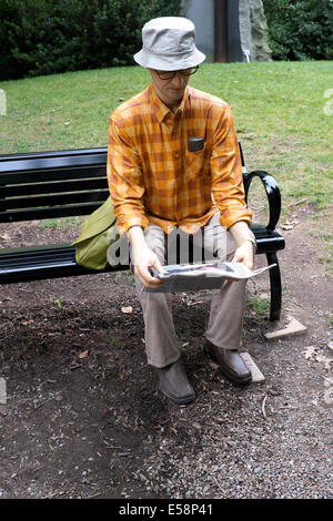 Inner World, Outer World - man reading newspaper on bench sculpture by Seward Johnson at the NJ Grounds for Sculpture Stock Photo