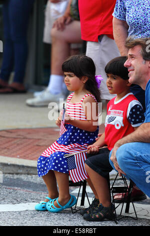 Caucasian girl in crowd wearing stars and stripes clothing during 4th July Independence Day parades, Catonsville, Maryland, USA Stock Photo