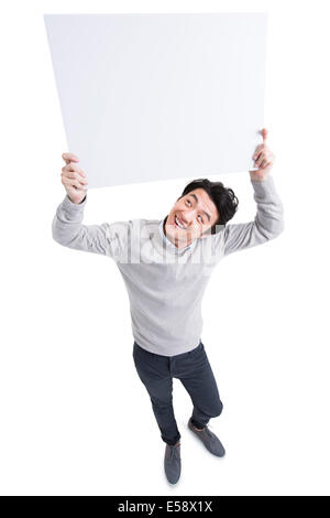 Cheerful young man holding whiteboard Stock Photo