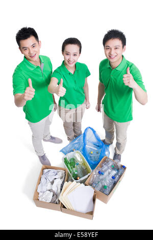 Happy volunteers giving thumbs up Stock Photo