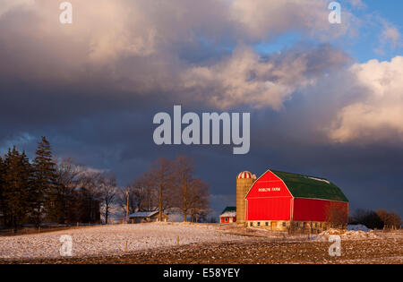 A red barn under stormy skies near Caledonia.  Roblyn Farm, Haldimand County, Ontario, Canada. Stock Photo