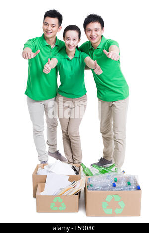 Happy volunteers giving thumbs up Stock Photo