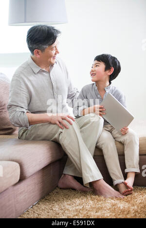 Happy grandfather and grandson with digital tablet Stock Photo
