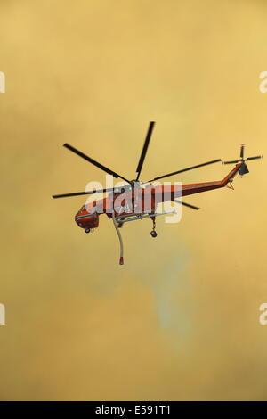 Aerial fire fighting a bush fire using water bomber helicopter in Western Australia. Stock Photo