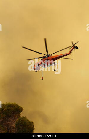 Aerial fire fighting a bush fire using water bomber helicopter in Western Australia. Stock Photo