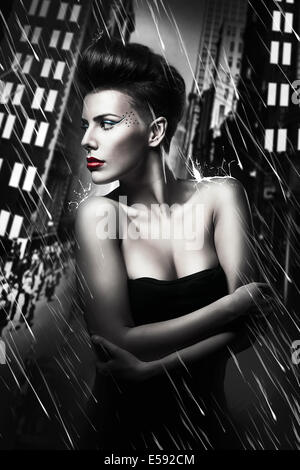 beautiful woman with red lips in rainy city Stock Photo