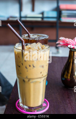 Iced coffee on the wooden table in coffee cafe. Stock Photo