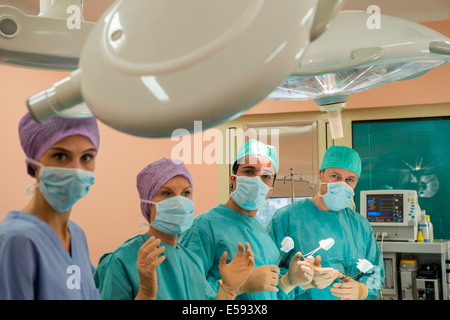 Medical team performing an operation in an operating room Stock Photo