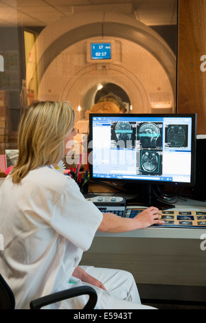 Female doctor examining brain MRI scan on computer Stock Photo
