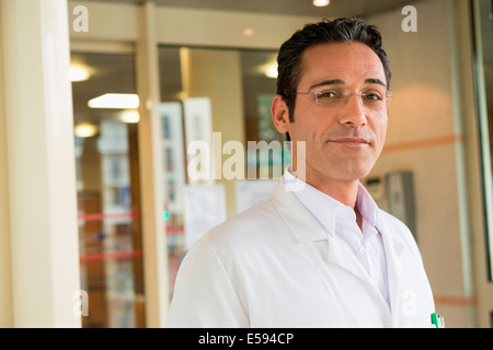 Portrait of a male doctor smiling in hospital Stock Photo