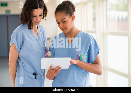Female nurses watching clip on a digital tablet Stock Photo